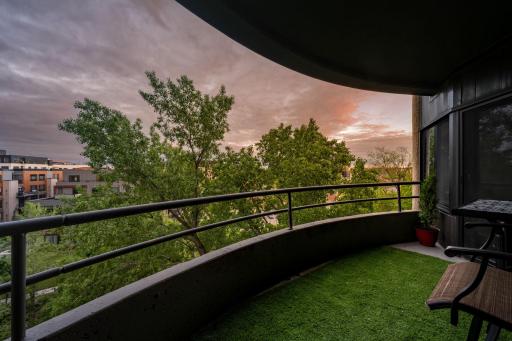 Private covered balcony with room for seating, treetop views, and a peaceful outdoor extension of the living space.