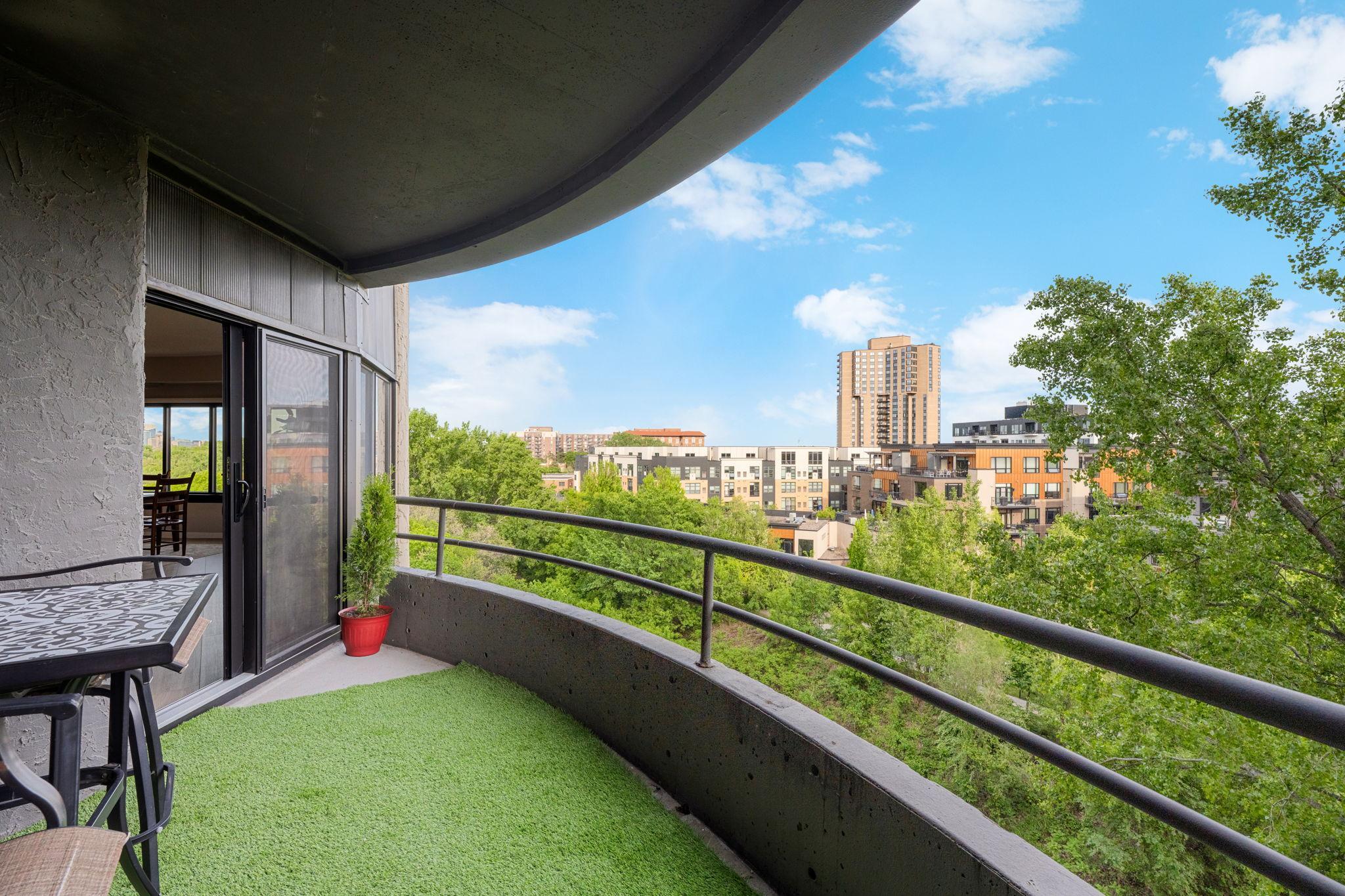 Covered balcony with elevated neighborhood views, treetop scenery, and a wonderful connection to the surrounding Calhoun Isles area.
