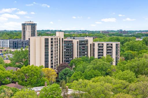 Elevated view of the Calhoun Isles community surrounded by mature trees, nearby lakes, and vibrant city conveniences.