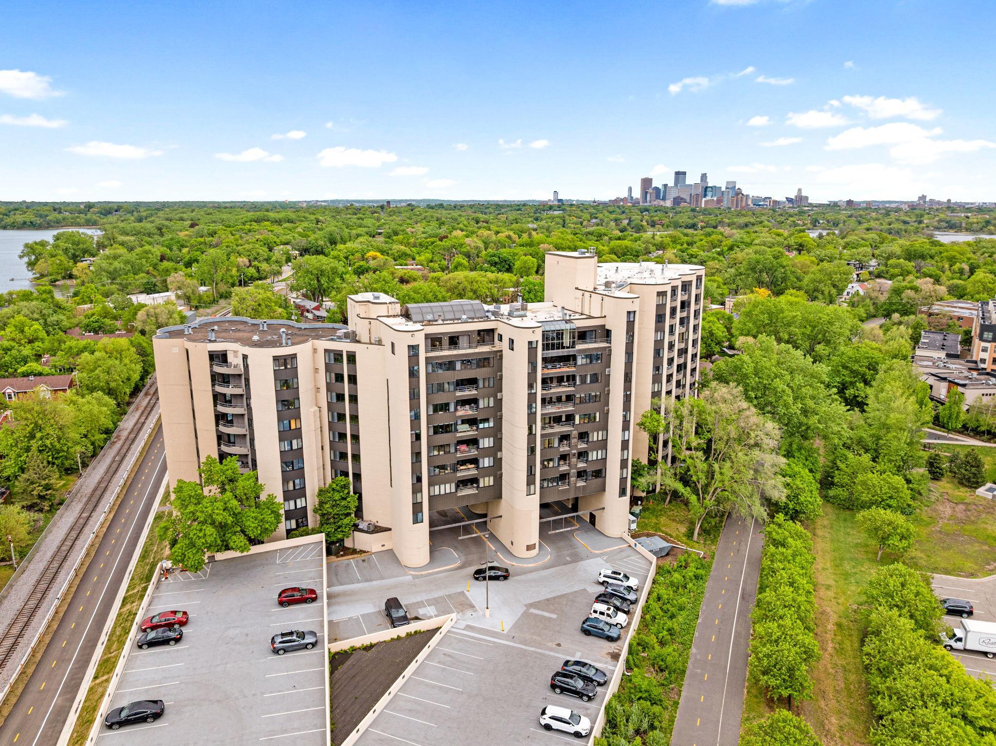 Distinctive Calhoun Isles building exterior surrounded by mature trees, showcasing its unique architectural design in a sought-after location.
