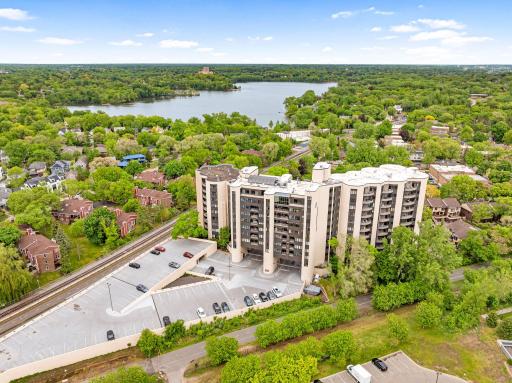 Wide aerial view highlighting the buildingâs incredible location near the lakes, parks, trails, and downtown Minneapolis skyline.