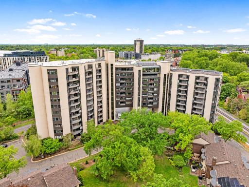 Aerial view of the Calhoun Isles community with downtown Minneapolis skyline views, nearby green space, and convenient surrounding amenities.