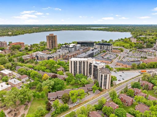 Expansive aerial view of Lake Bda Maka Ska, surrounding neighborhoods, Greenway, and convenient access to the Calhoun Isles area.