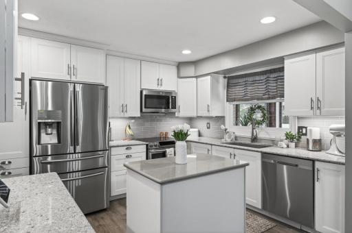 The renovated kitchen delivers â white shaker cabinetry, quartz countertops, stainless French door refrigerator, slide-in range, built-in microwave, and dishwasher. Every detail updated.