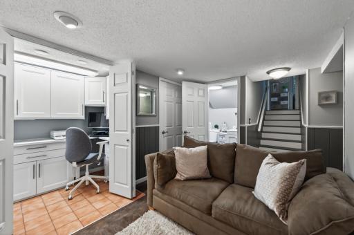 The lower level delivers even more finished space â a rec room with a full built-in office nook (white cabinetry, desk area) and access to the renovated bath and laundry.