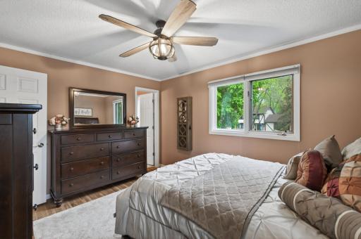 Spacious primary suite with room for a full furniture set â the walk-through to the private Â¾ bath is just beyond the dresser.