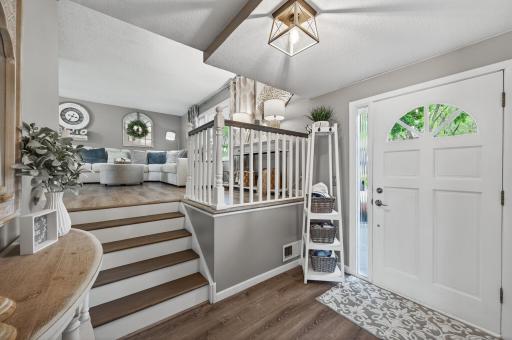 The multi-level split layout gives great separation of spaces. Updated stair treads and freshly painted white railing tie it all together visually.