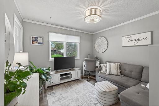 Well-proportioned upper-level bedroom with LVP flooring, two windows, and plenty of natural light. Ample closet space.