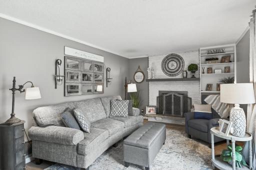 Full view of the entry-level family room showing the comfortable seating area, LVP flooring, and the relaxed farmhouse-transitional style carried throughout the home.
