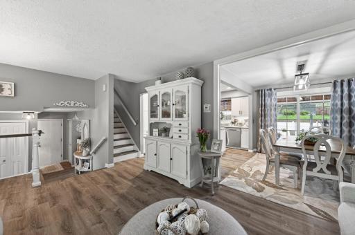 From the living room, sightlines open straight through to the kitchen and dining area â the upper entertaining level feels cohesive and naturally connected.