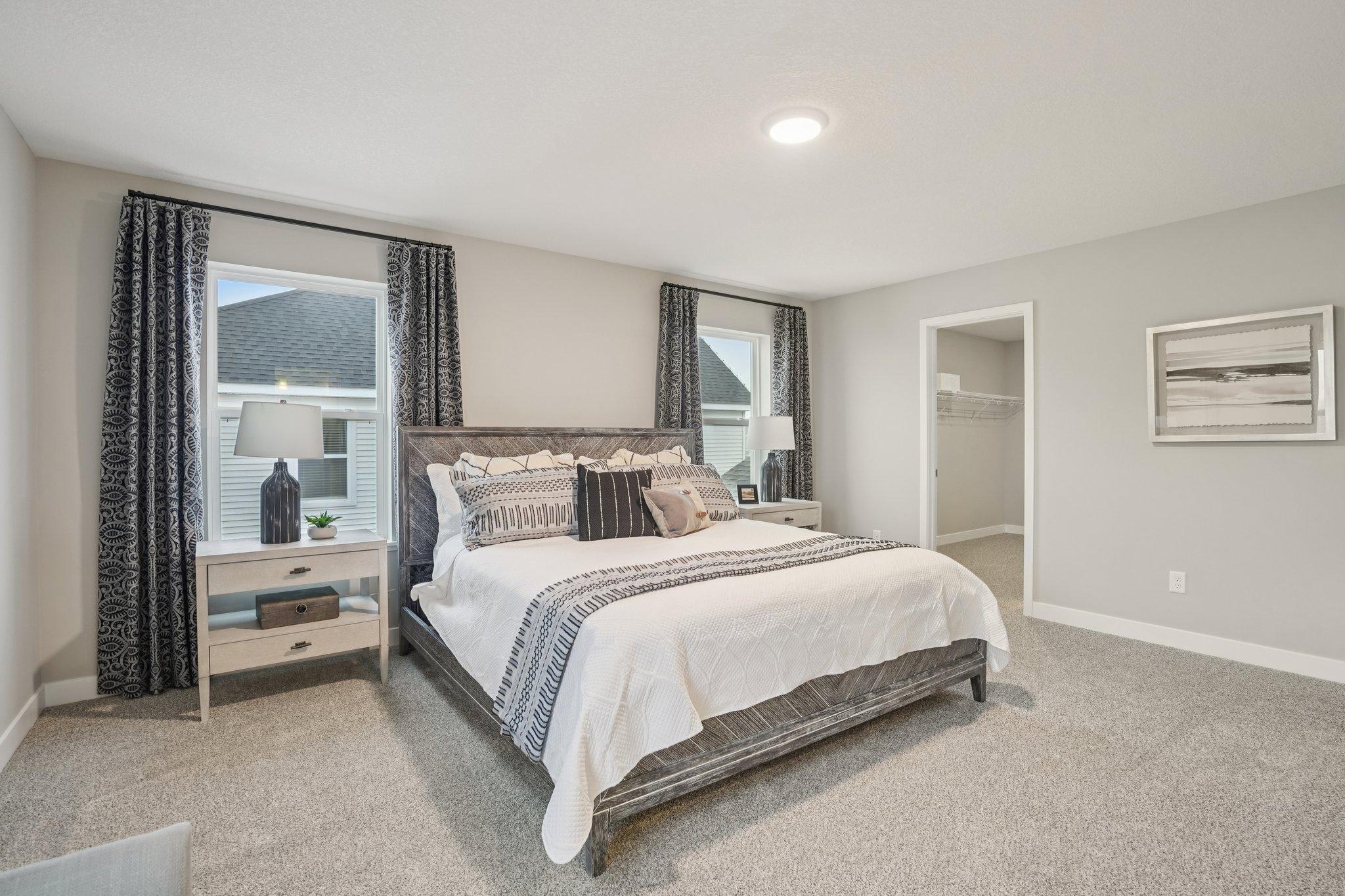 Plenty of space for a king size bed, furniture, and well lit, this primary suite really is the perfect oasis to escape to. (Photos of model. Colors and finishes may vary).
