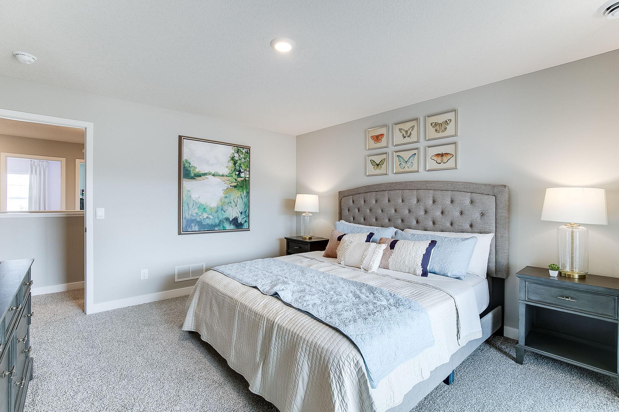 Primary suite. Large enough for all the King bed, dresser, nightstands, and more! Model photo. Options and colors will vary.