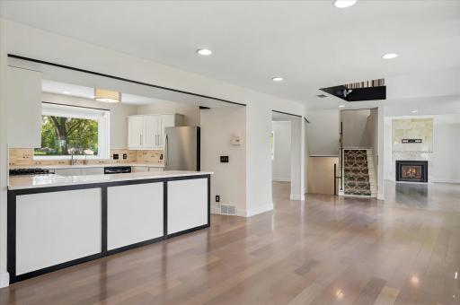 Dining open to kitchen and screened porch and deck