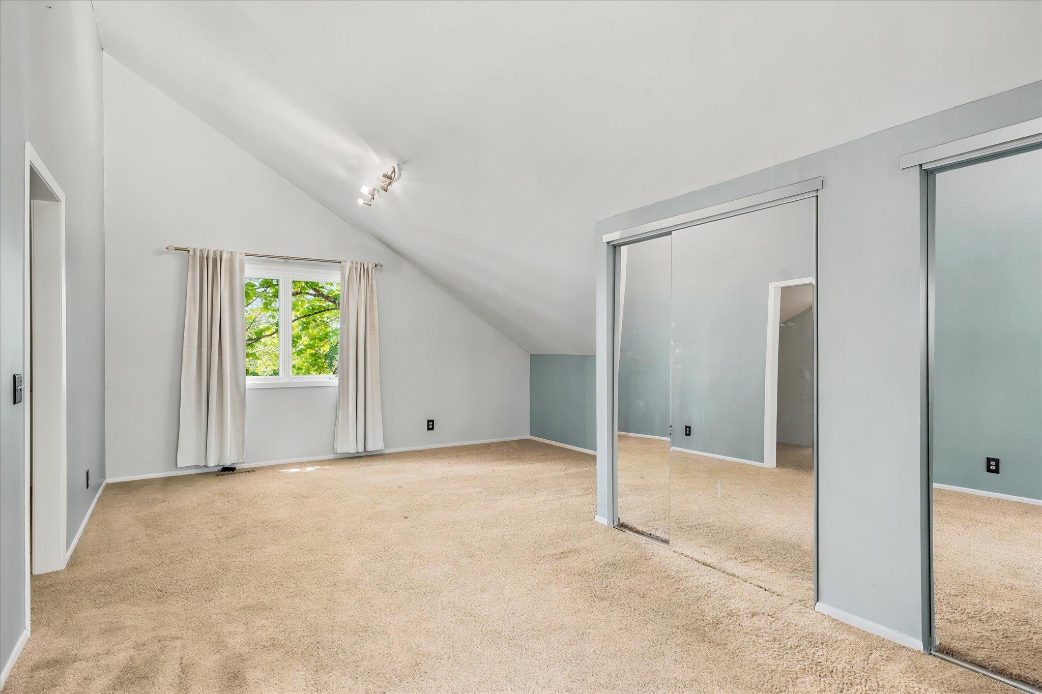 Vaulted Primary Bedroom (1 of 5) with 1/2 Bath.