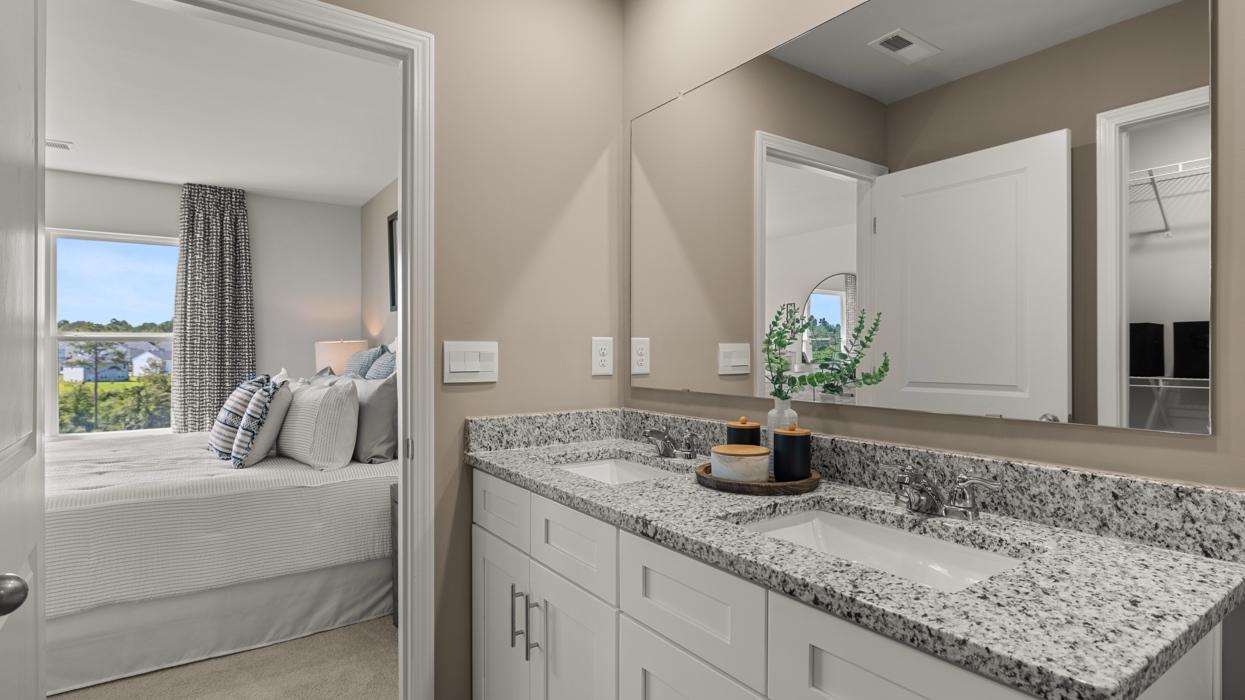 Primary suite. Actual home will include quite quartz countertops. All photos used are of a previous model home.
