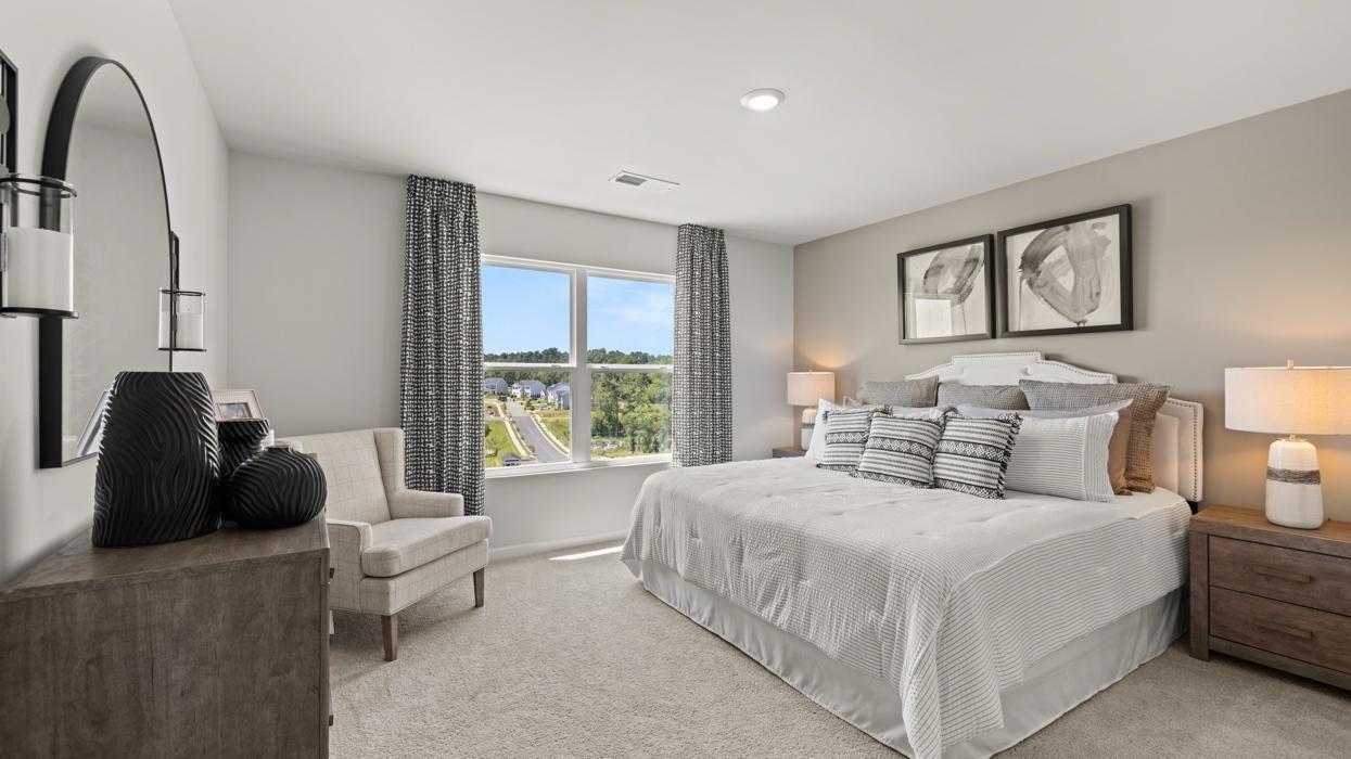 Spacious primary bedroom! All photos used are from a previous model.