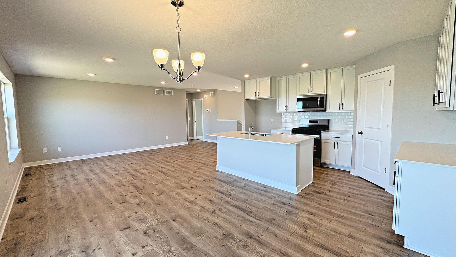 Open concept layout in Kitchen/Dining/Living rooms. Photos represent another Dallas home previously for sale. Colors and options may vary.