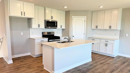 The Kitchen Island is a great place to gather and provides extra seating. Photos represent another Dallas home previously for sale. Colors and options may vary.