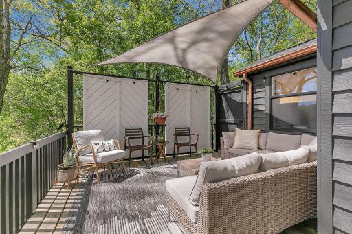 Private deck lounge off of Bedroom 1 - fully enclosed with gate to walk down to lake