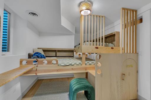 Bedroom 3 with custom built bunk beds and play space below. Also features a walk in closet