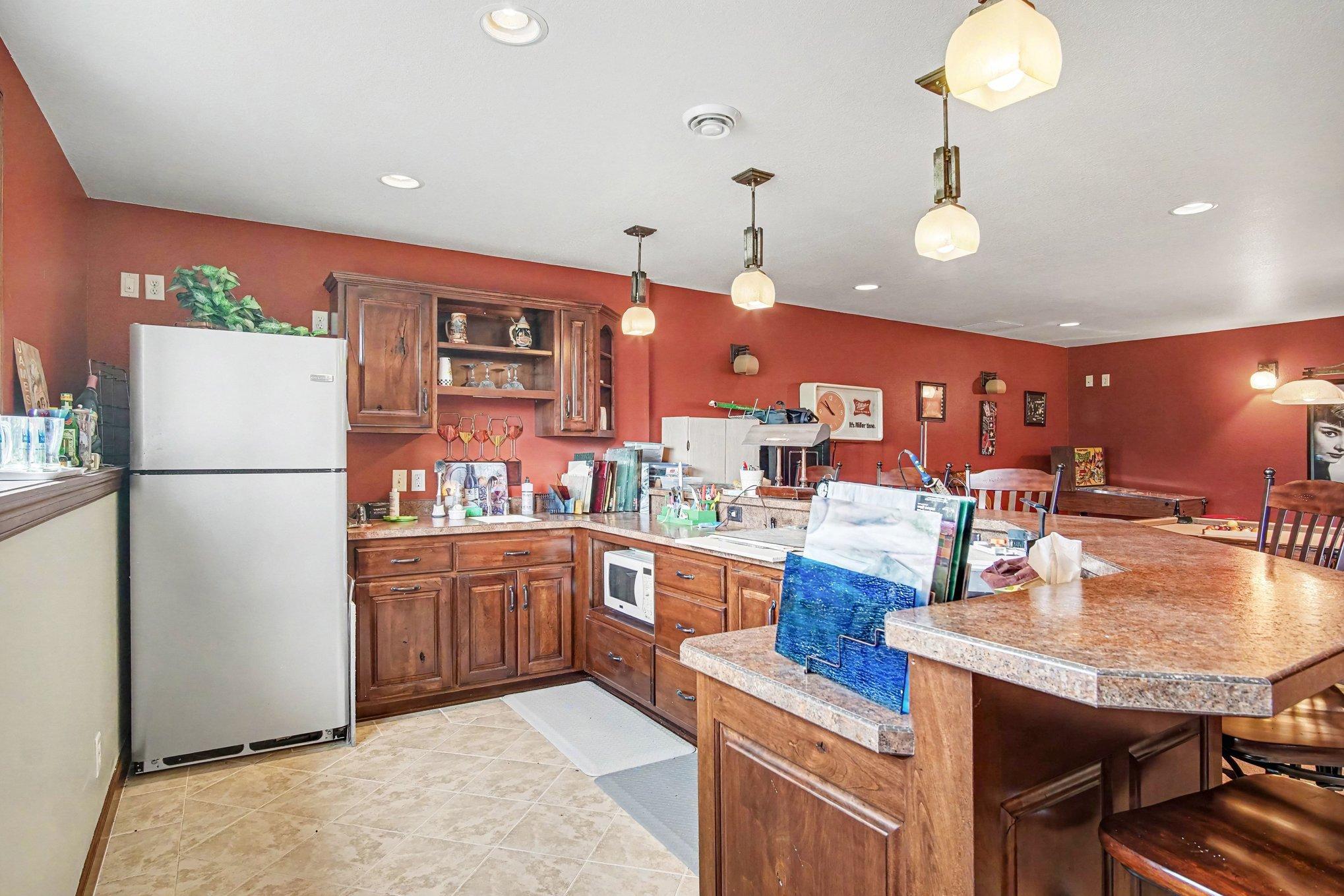 Plenty of space behind the bar-generous cabinets and plenty of natural light