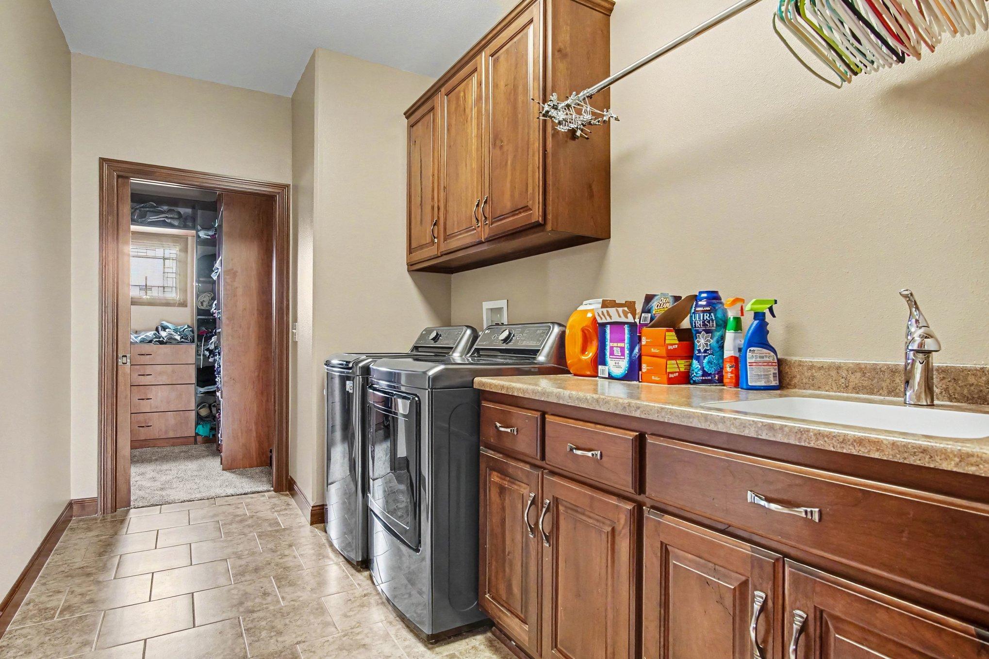 Laundry room on main floor- plenty of storage cabinets/countertops