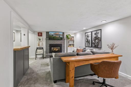The finished lower level provides additional living space with a family room featuring a gas fireplace, exercise room, fourth bedroom, spacious three-quarter bathroom, and laundry area.