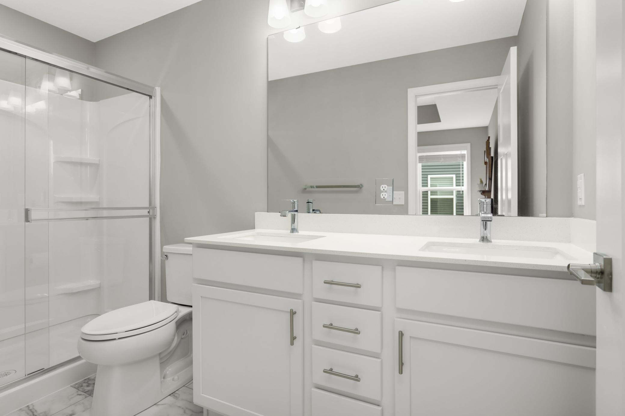 Owner's 3/4 private bath has shower and dual vanity.