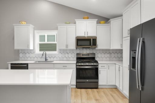 Stunning quartz countertops, beautiful backsplash and stainless steel appliances.
