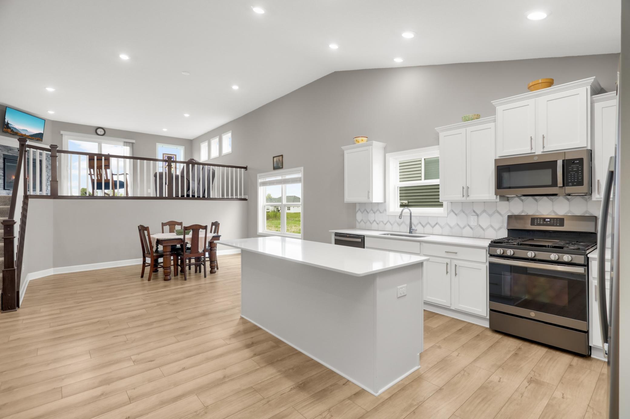 Tall ceilings, recessed lighting, neutral paint and luxury vinyl flooring throughout this entry level.