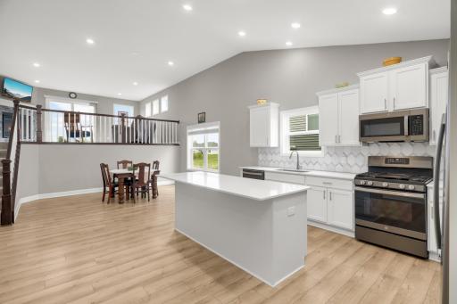 Tall ceilings, recessed lighting, neutral paint and luxury vinyl flooring throughout this entry level.
