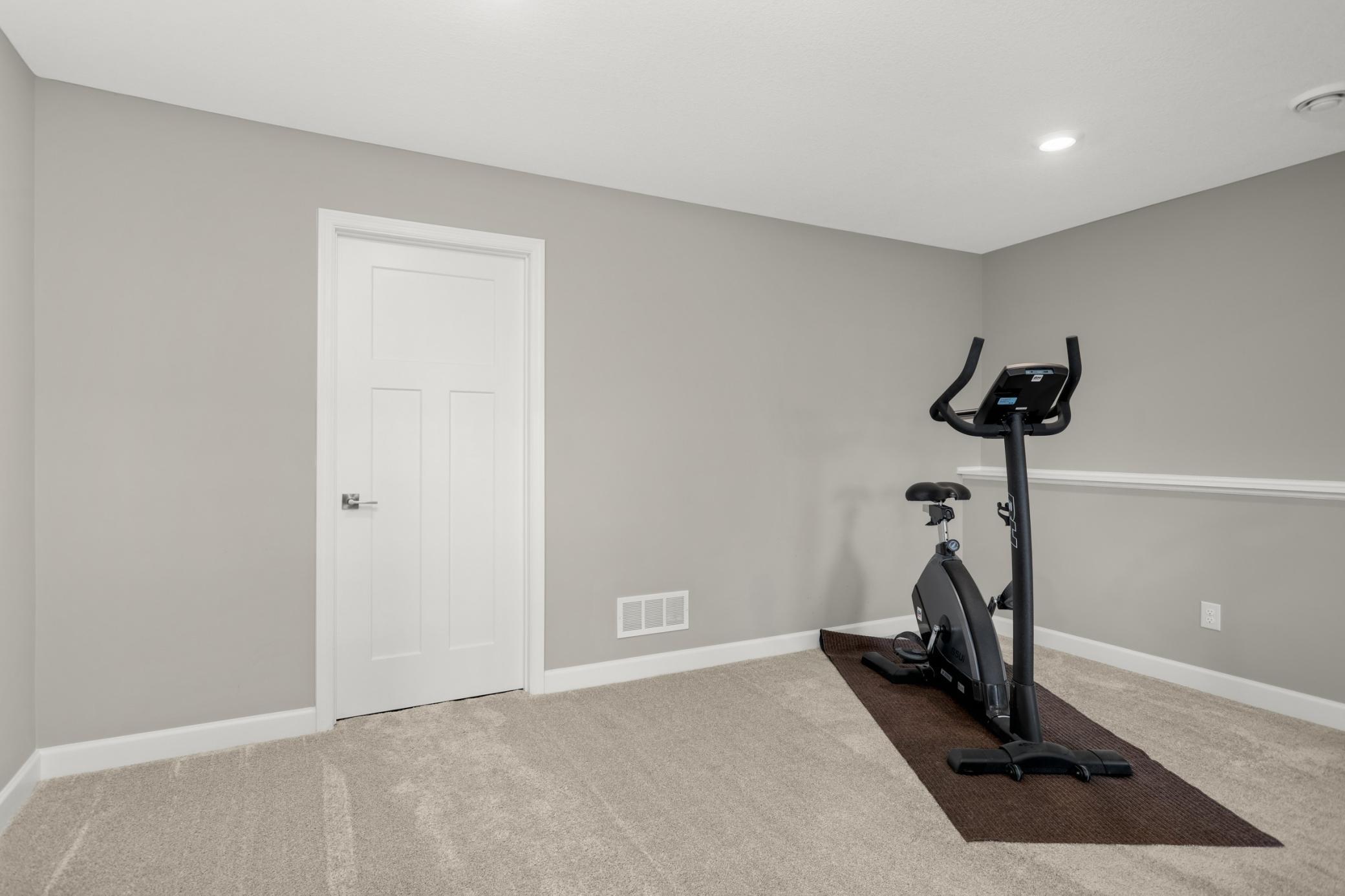 Bump out/flex space in the family room is great for an exercise space. The door goes to the mechanical room.