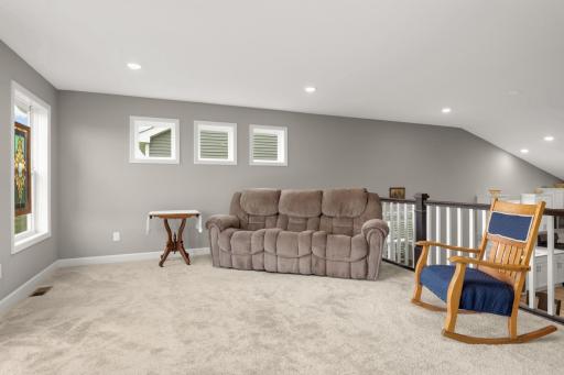 Up the stairs to the living room. Plush carpet, plenty of natural light and overlooking the dining/kitchen areas.