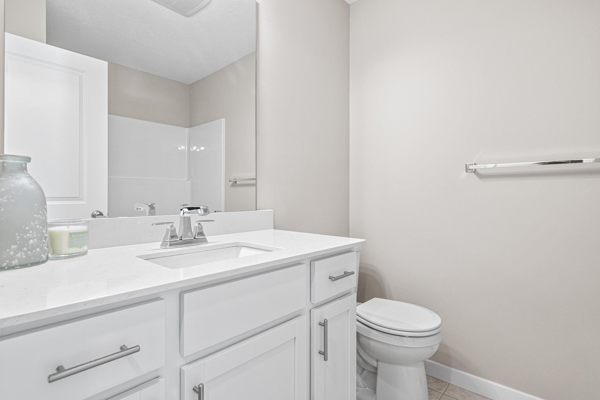 Main Bathroom. Photo taken of another home with similar plan and finishes. Photos and renderings may not depict actual plan, materials, & finishes may vary. All measurements are approximate.