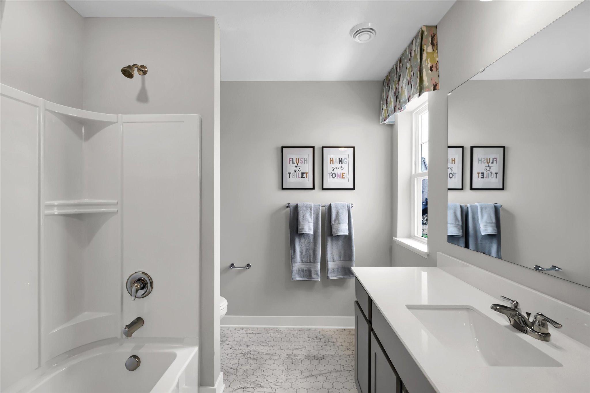 Primary bathroom with Quartz counters.