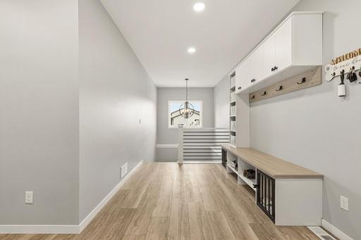 This foyer leaves a lasting impression. Just inside the attached garage - perfect for kids to drop off their backpacks, coats, and shoes in an organized space!