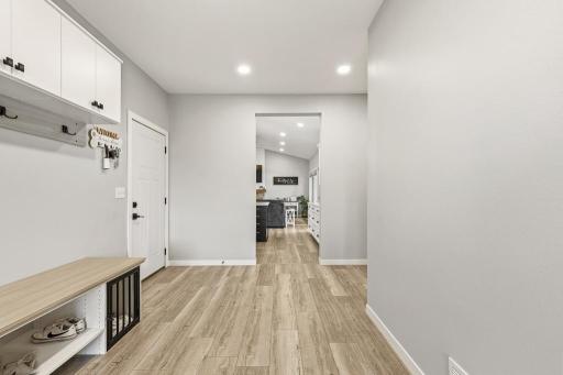 Attached garage entry opens up to the kitchen, the primary bedroom (to the right) and access to the lower level