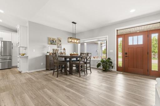 A formal dining space enhanced by a hanging light fixture offers the perfect space for evening dinners