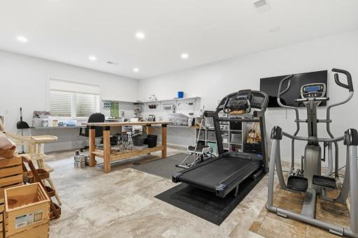 This spacious bonus room in the lower level could be a large bedroom if needed! But it functions great as a multi-purpose, workout, crafting, hobby room!