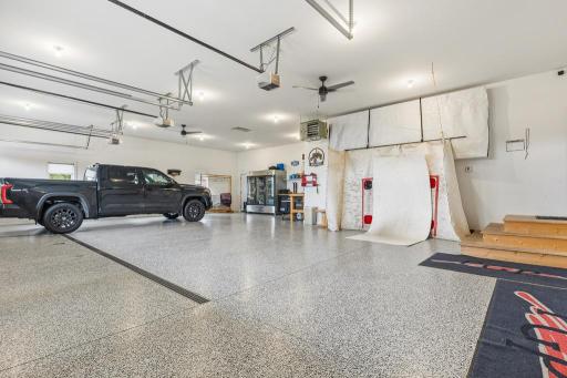 The interior of the garage is just as impressive as the rest of the home with epoxy flooring, a large floor drain, supplemental heat, and space to work or play