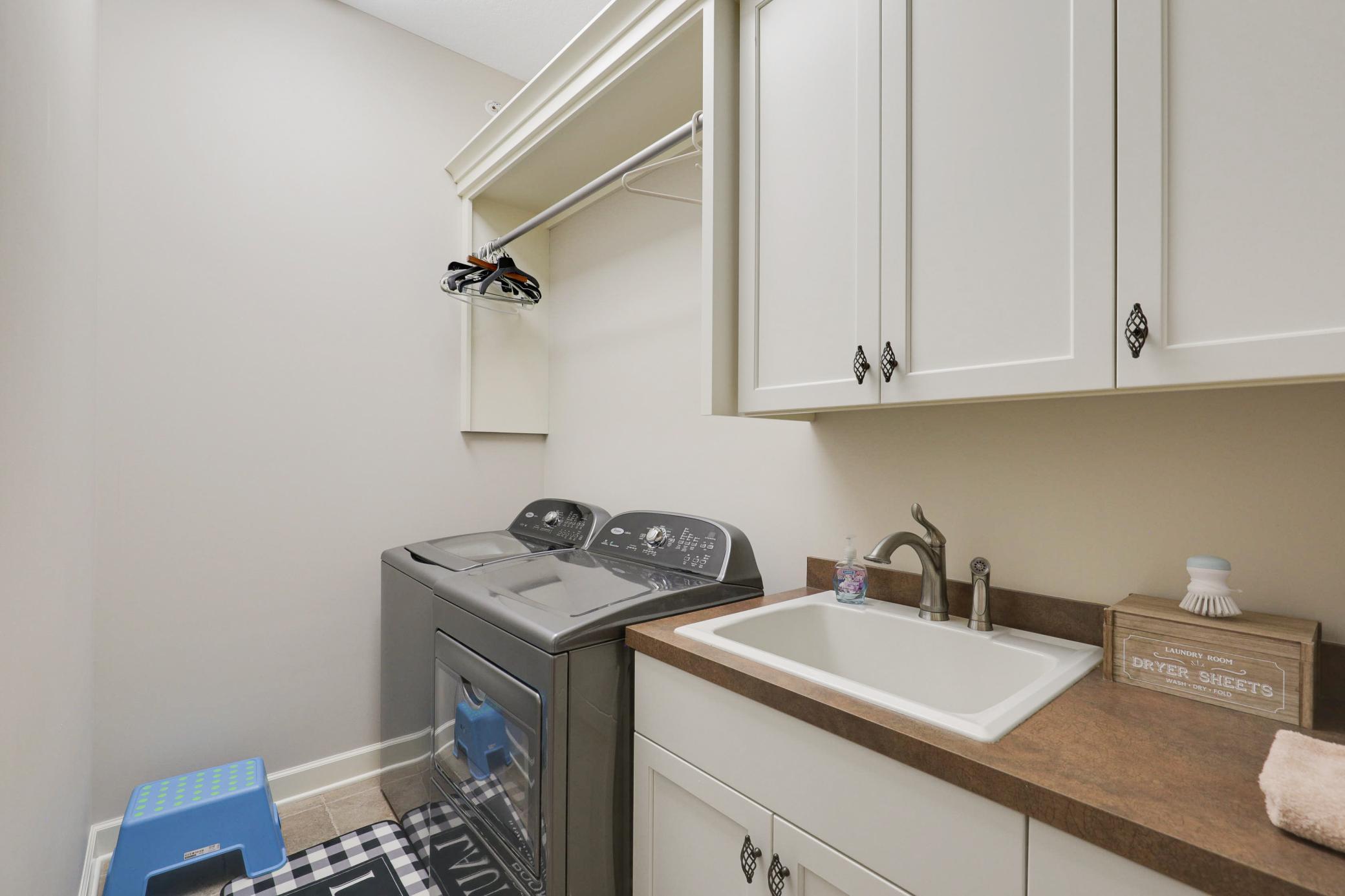 A dedicated main-floor laundry room enhances everyday ease, and a convenient half-bathroom serves the main floor common spaces.