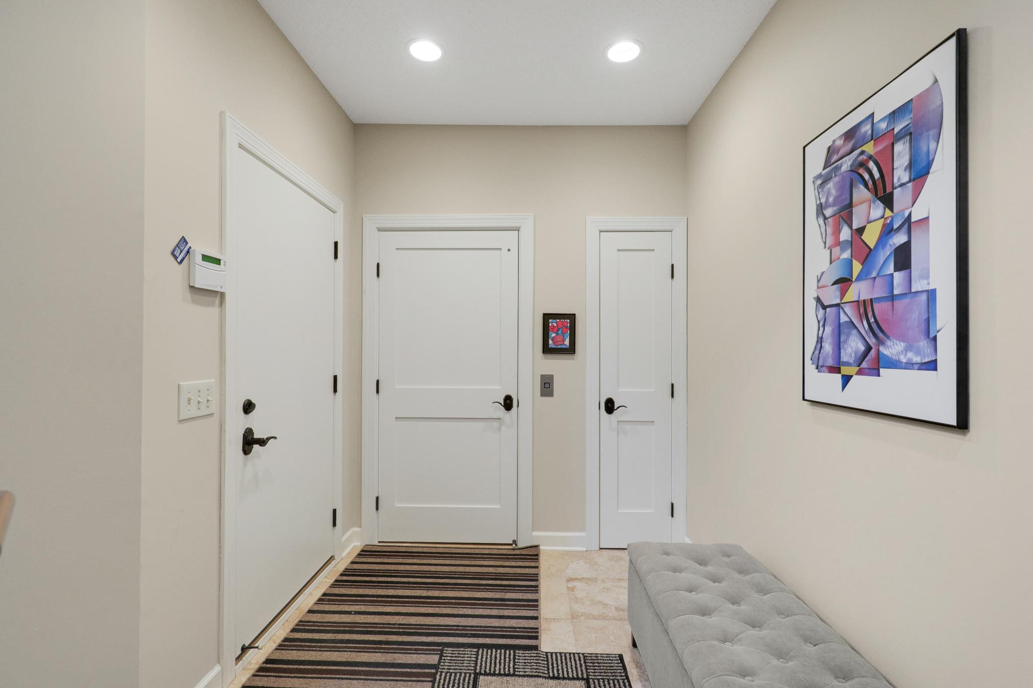 The lower level provides a generously sized third bedroom with a private full bath, dual closets, and direct access to the backyard, plus a utility room and dedicated storage space.