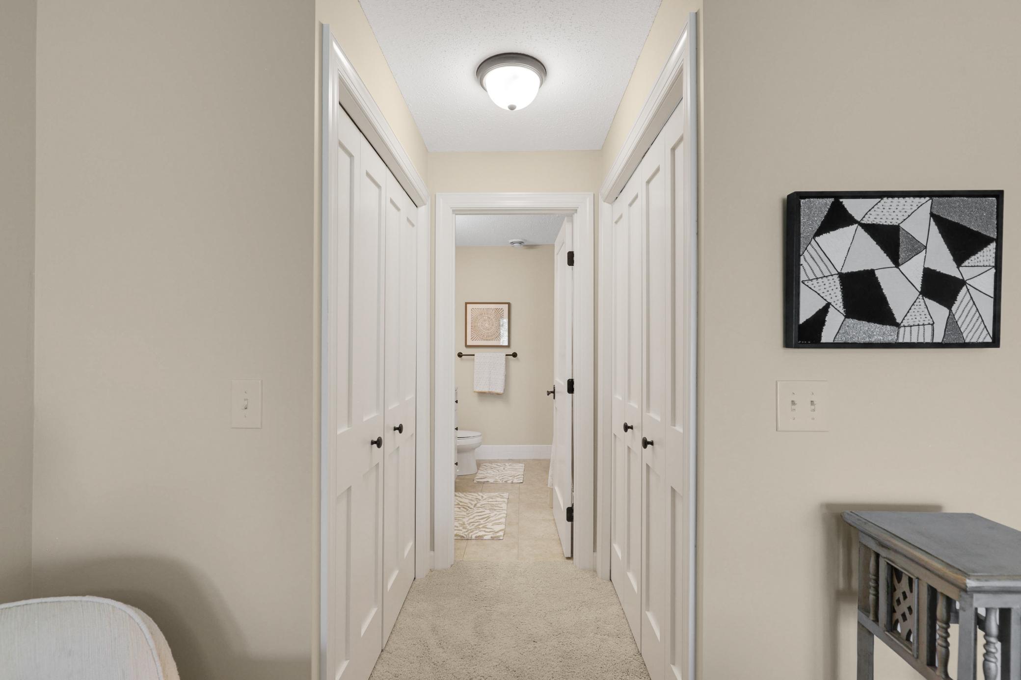 The lower level provides a generously sized third bedroom with a private full bath, dual closets, and direct access to the backyard, plus a utility room and dedicated storage space.