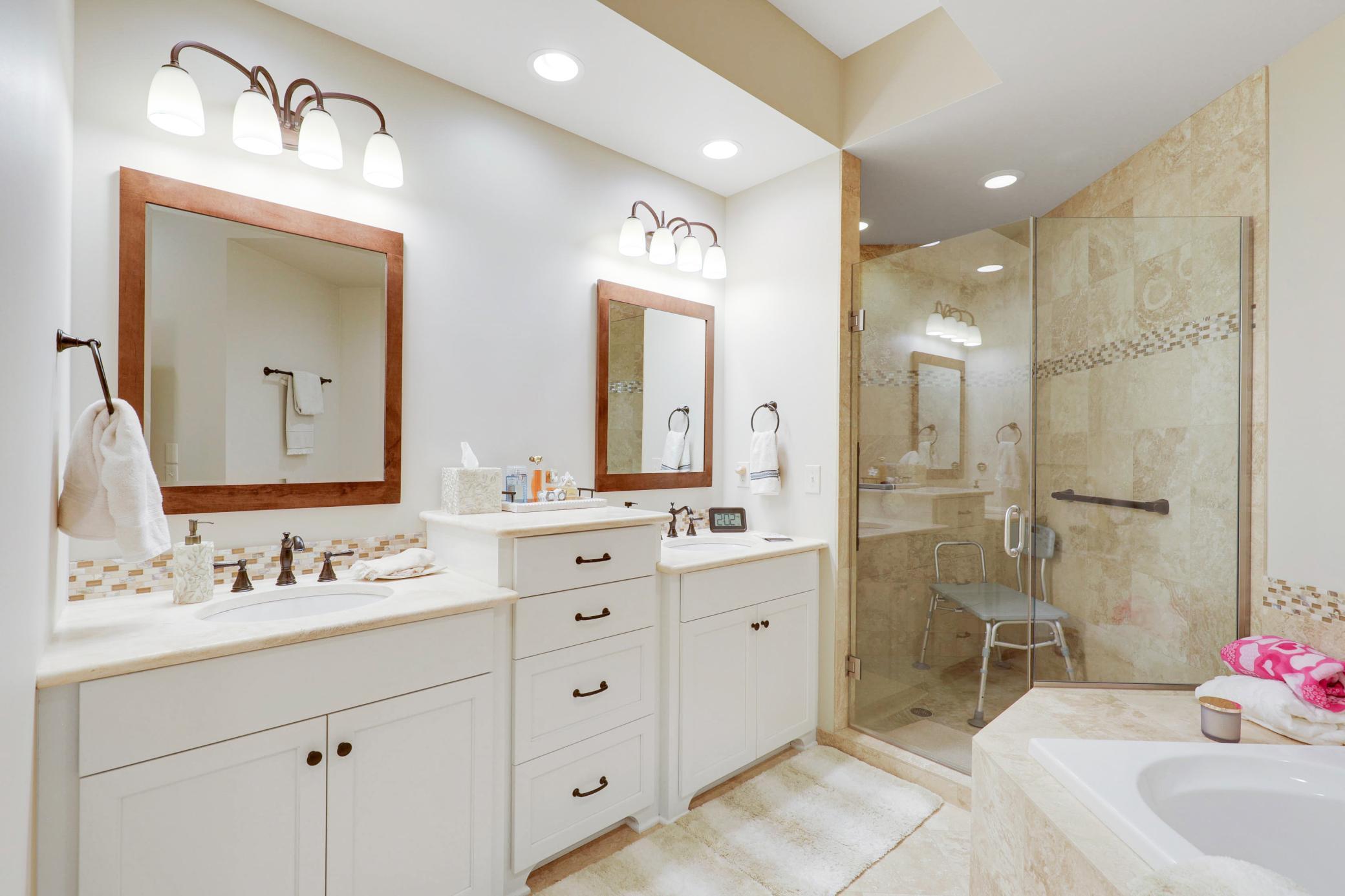 Retreat to a luxurious primary suite featuring serene nature vistas, dual walk-in closets, dual sinks, a soaking tub, a walk-in shower, and a separate water closet.