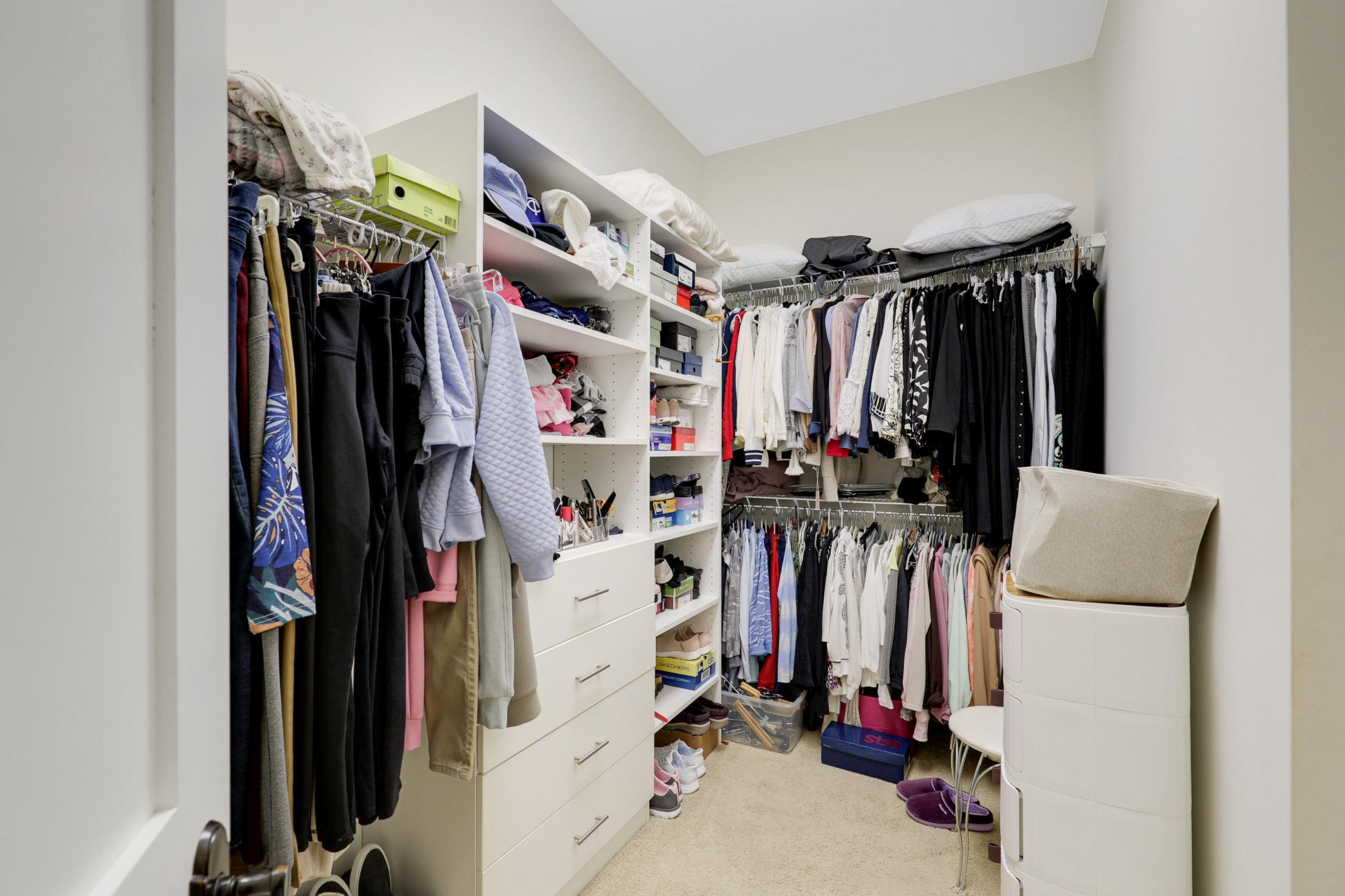 Retreat to a luxurious primary suite featuring serene nature vistas, dual walk-in closets, dual sinks, a soaking tub, a walk-in shower, and a separate water closet.