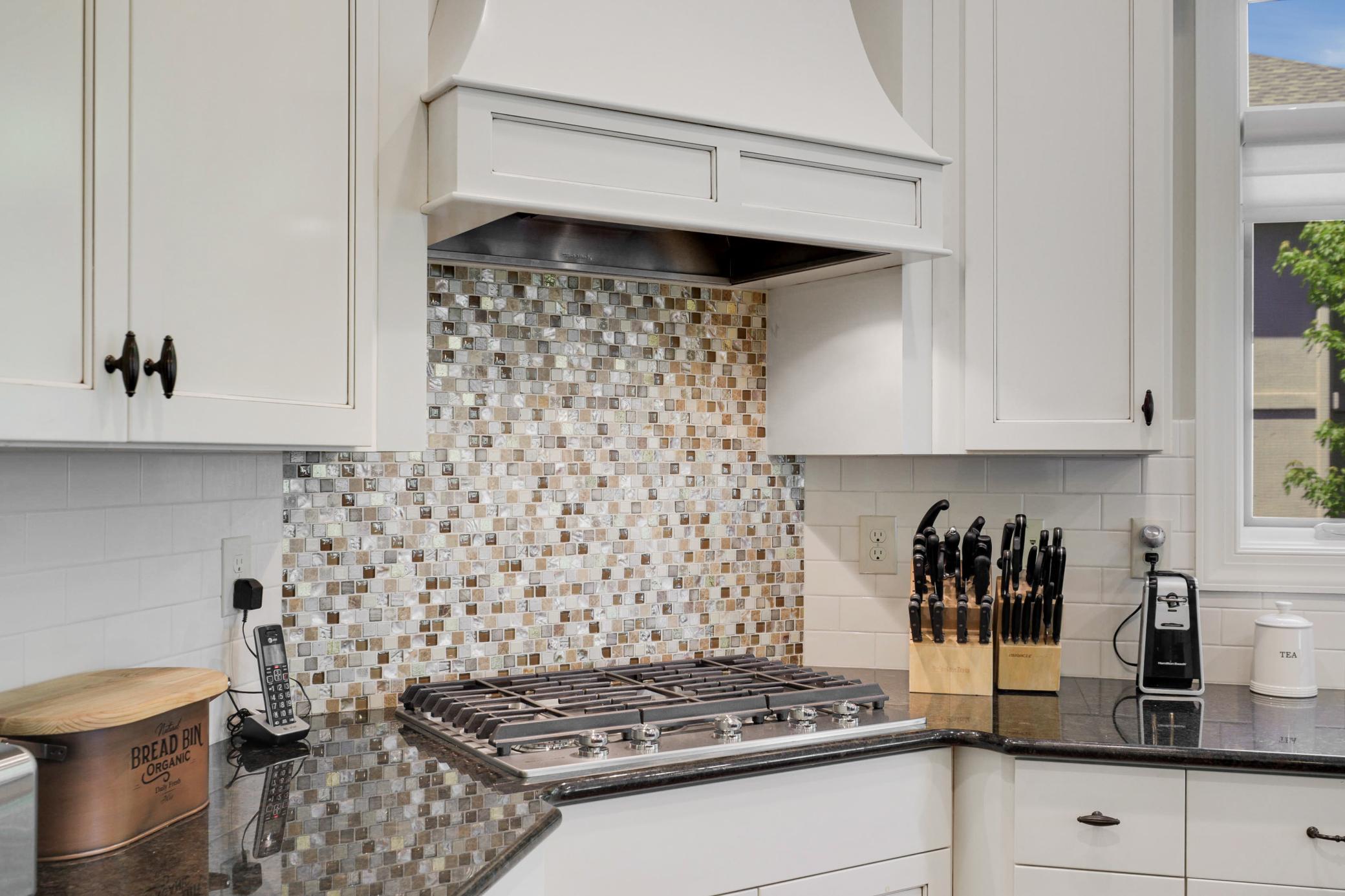 Enjoy cooking in your gourmet kitchen which showcases stone countertops, ample cabinet storage and stainless steel KitchenAid appliances.