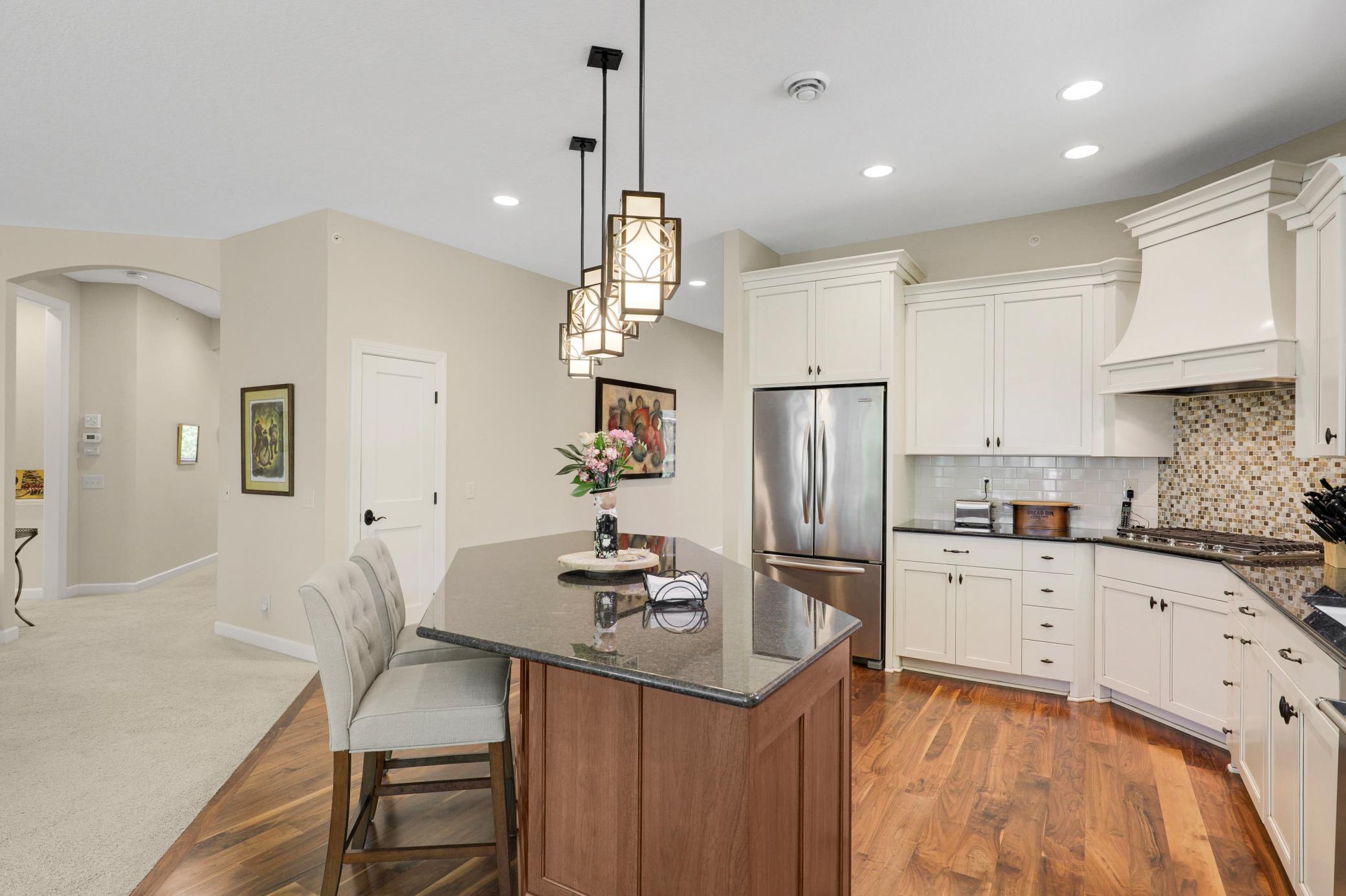 Enjoy cooking in your gourmet kitchen which showcases stone countertops, ample cabinet storage and stainless steel KitchenAid appliances.
