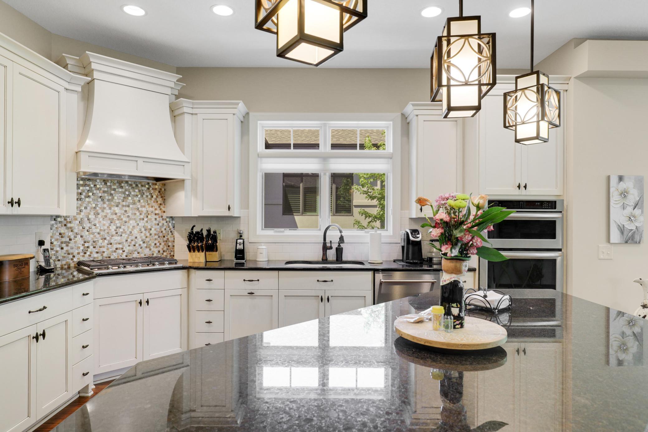 Enjoy cooking in your gourmet kitchen which showcases stone countertops, ample cabinet storage and stainless steel KitchenAid appliances.