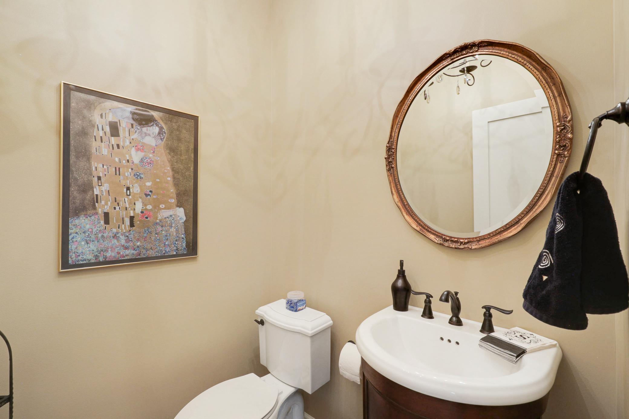 A dedicated main-floor laundry room enhances everyday ease, and a convenient half-bathroom serves the main floor common spaces.