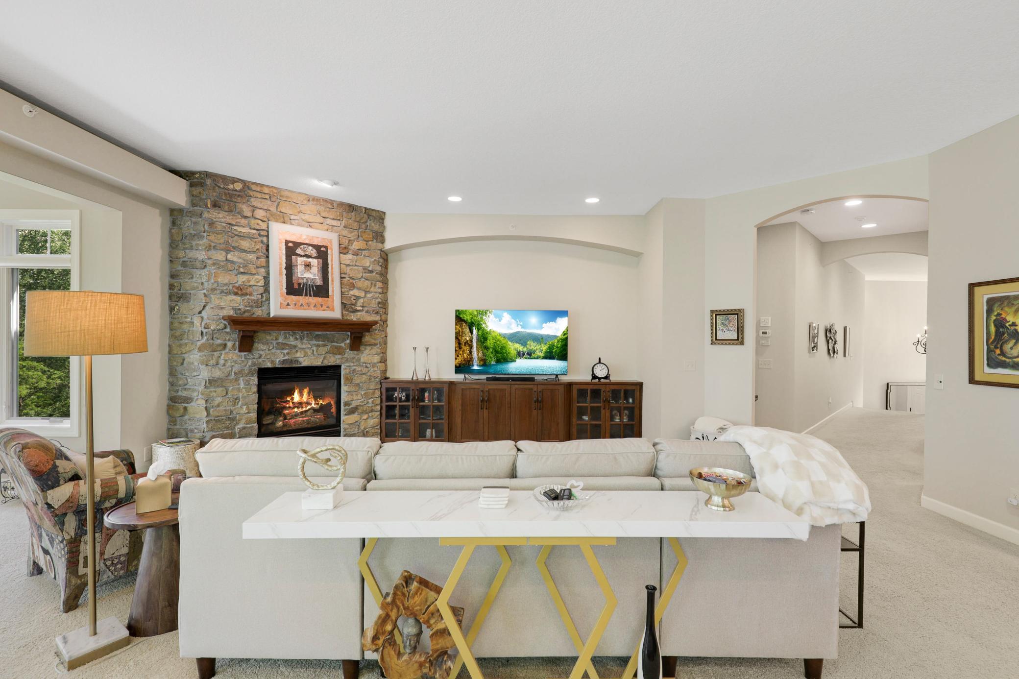 The expansive, open-concept kitchen, living and dining area is framed by tranquil views of the protected wetland behind the home.